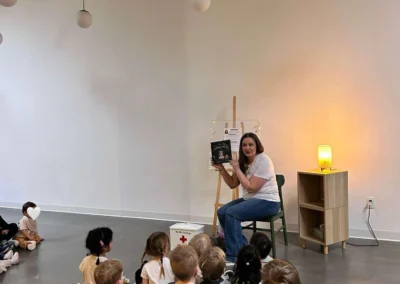 Author talking about her book in front of group of kids.